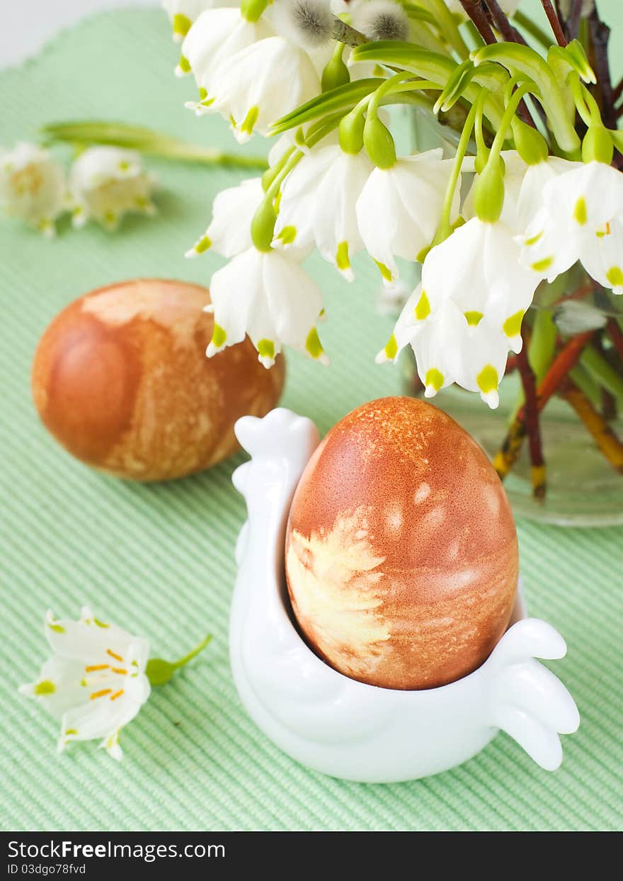 Easter Eggs in chicken shaped eggcup with flower