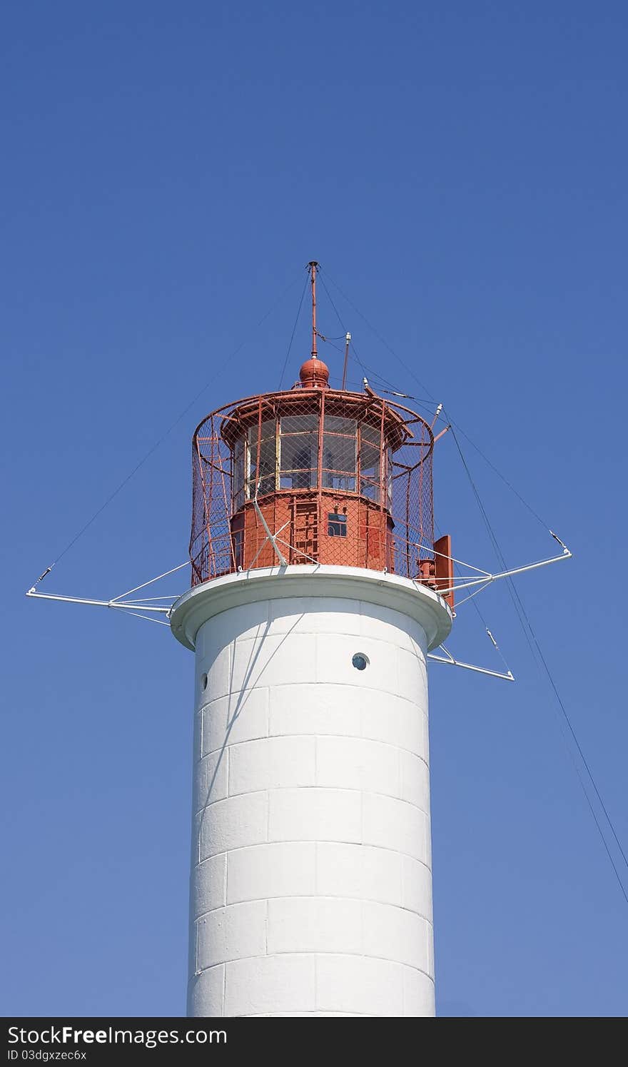 White lighthouse on a background blue sky