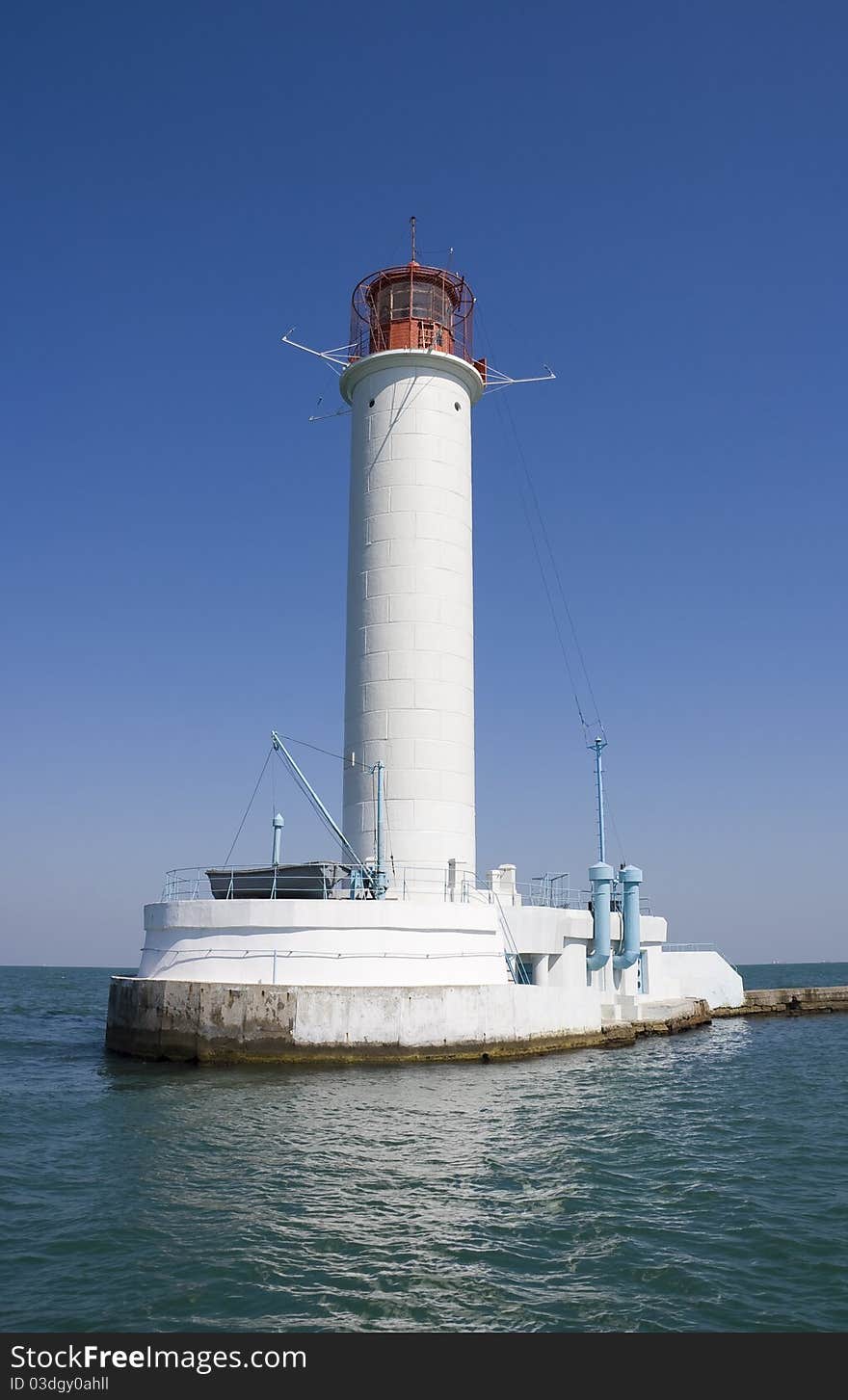 White lighthouse on a background blue sky