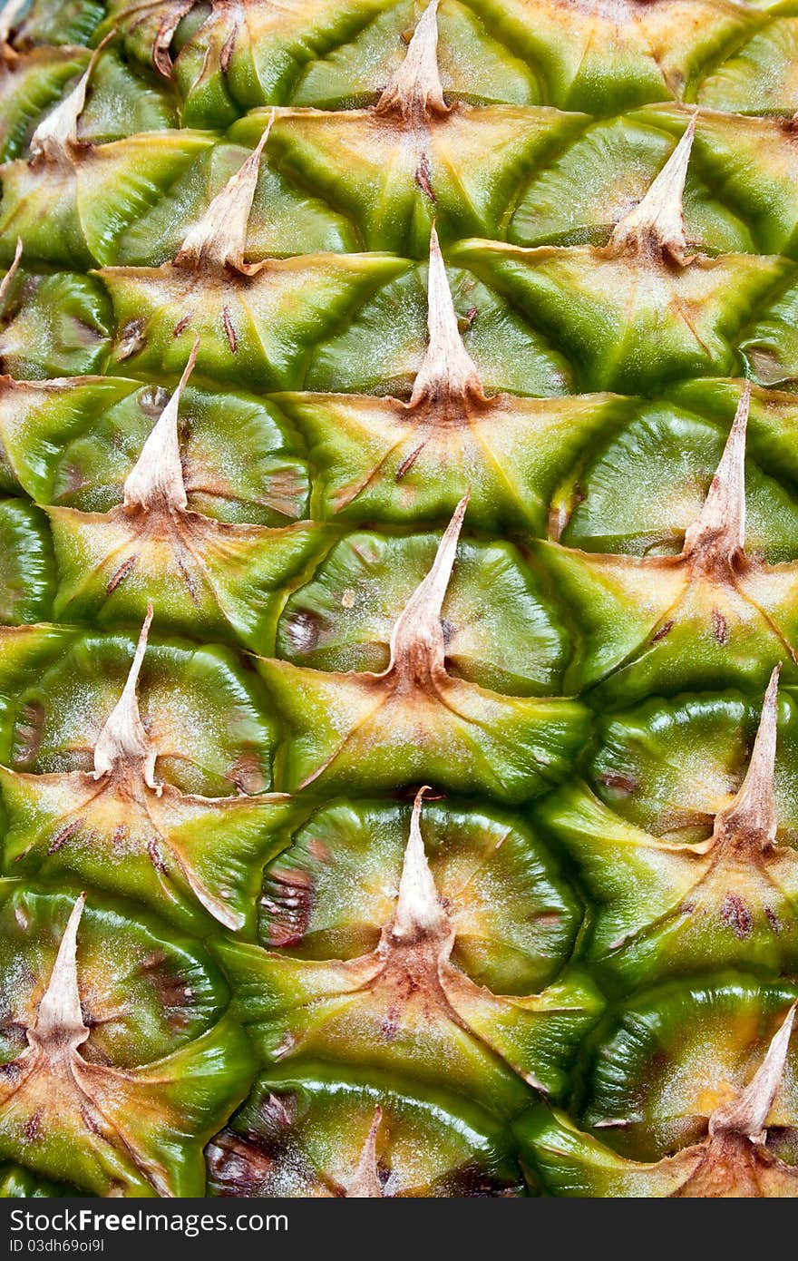 Textured surface of pineapple as a background