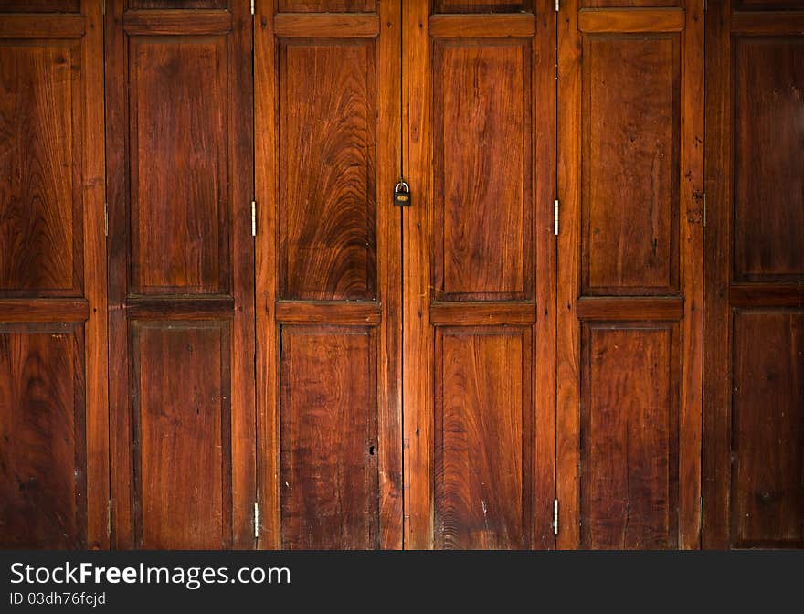 Texture of old wood door close and lock with key