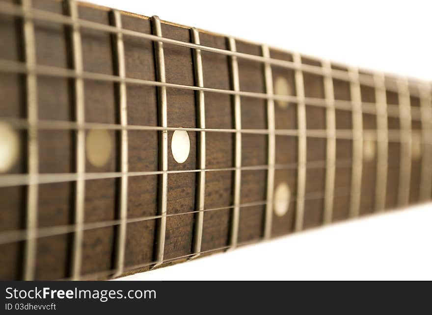 Guitar fretboard close up isolated on white