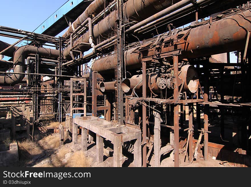 Rusty disused steel plant pipes