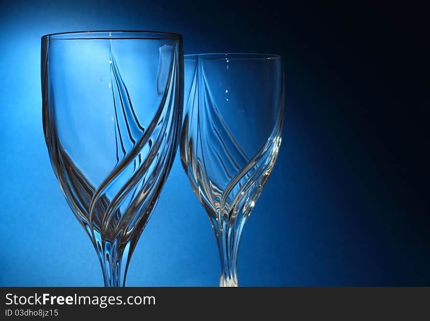 Drinking glasses on blue background with selective coloring