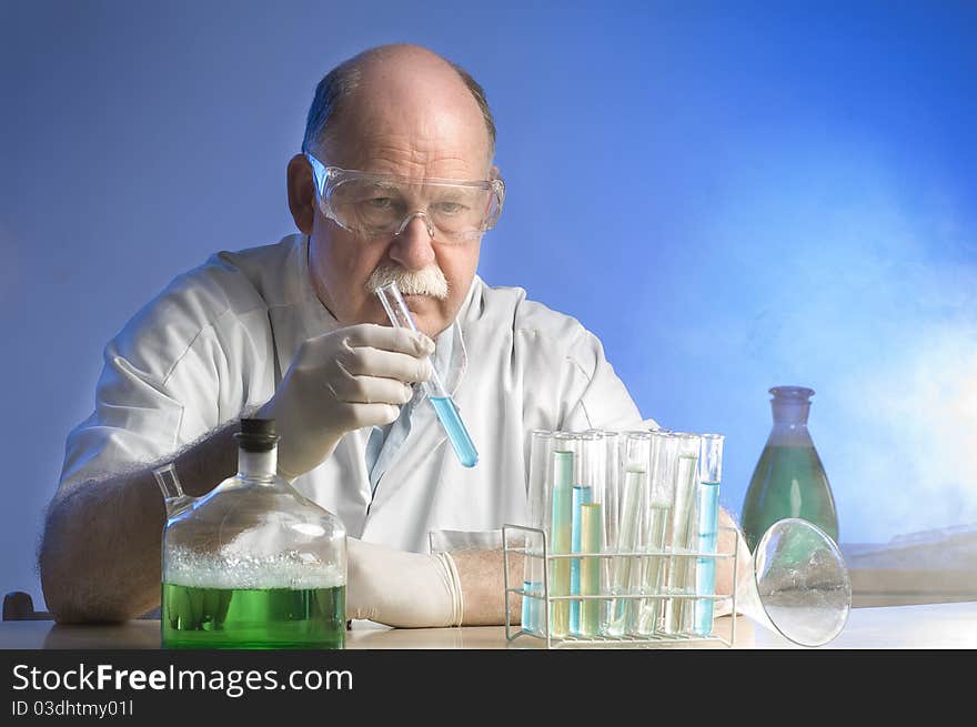 Scientist working with chemicals on blue background