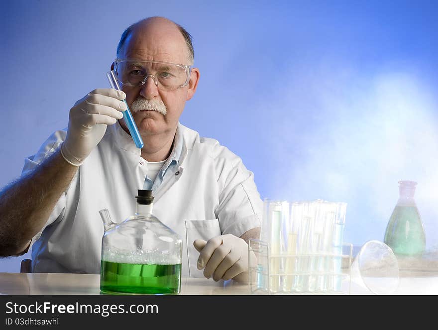 Scientist working with chemicals on blue background