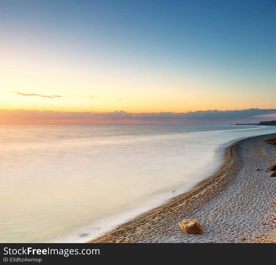 Beautiful seascape. Sea and rock at the sunset. Nature composition.