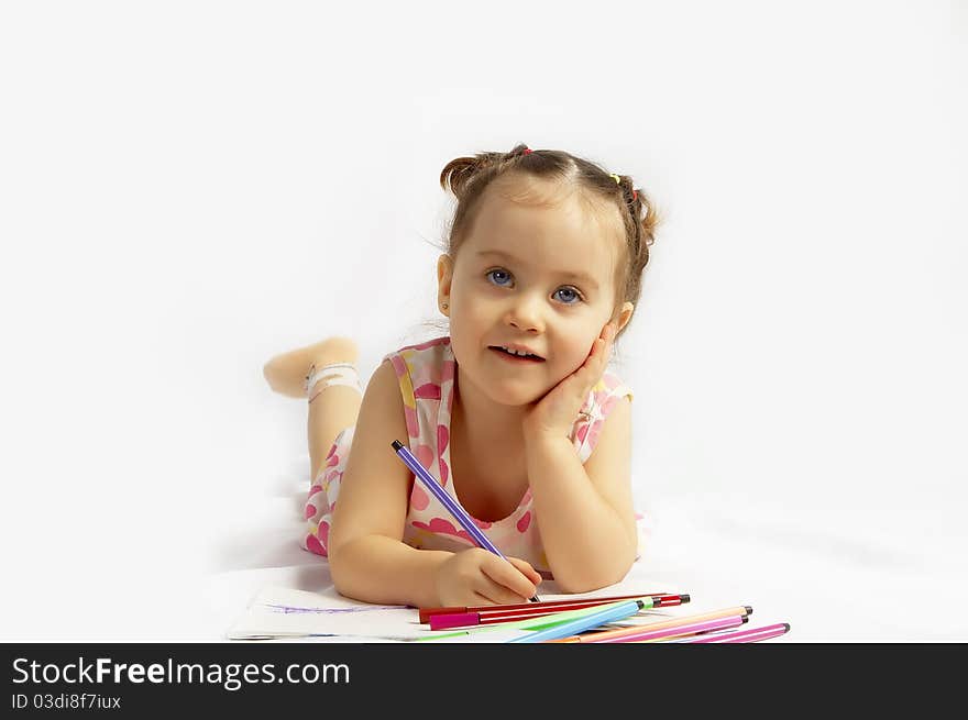 The beautiful girl drawing pencils in a sketch pad on the isolated white background