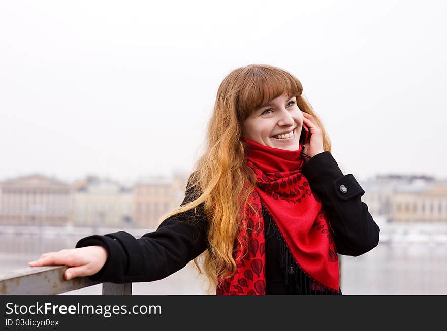 Young girl in the red scarf calling on phone