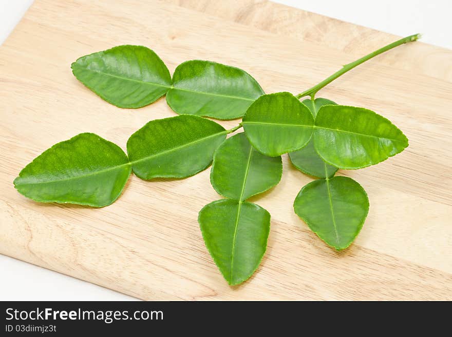 Kaffir lime leaf on wood cut board