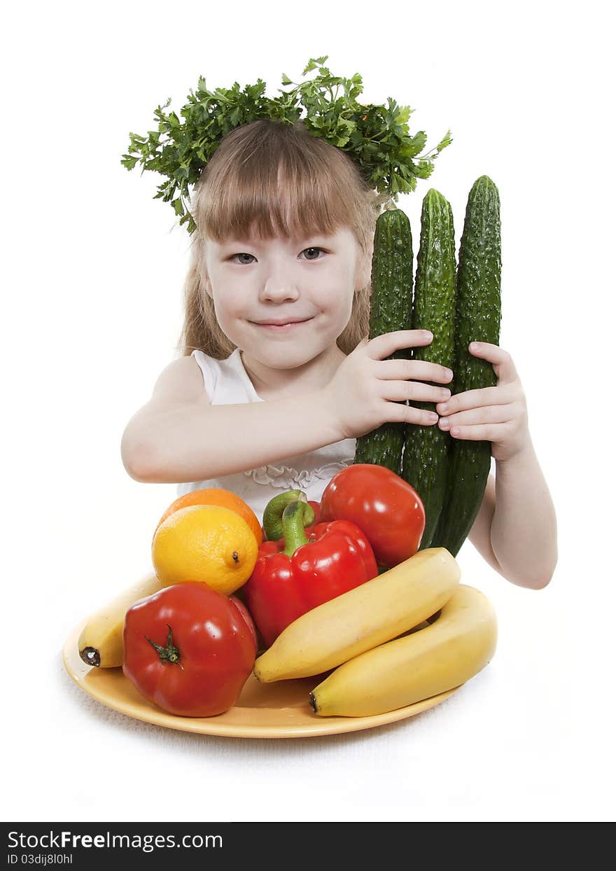 Vegetables and fruit it are a healthy food of children. Child holds different vegetables and fruit. Vegetables and fruit it are a healthy food of children. Child holds different vegetables and fruit.