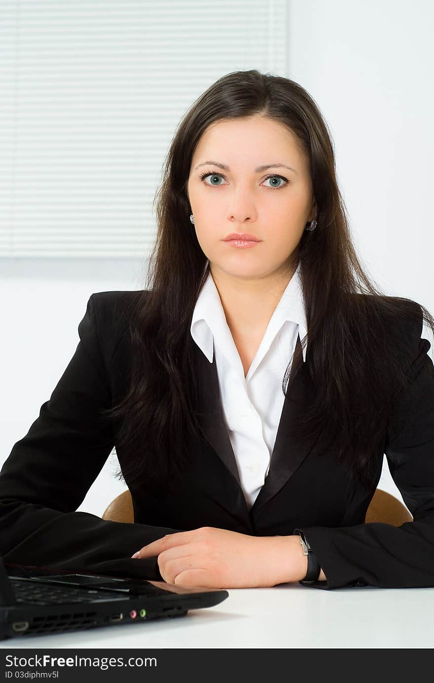 Beautiful girl in a business suit working in the office. Beautiful girl in a business suit working in the office