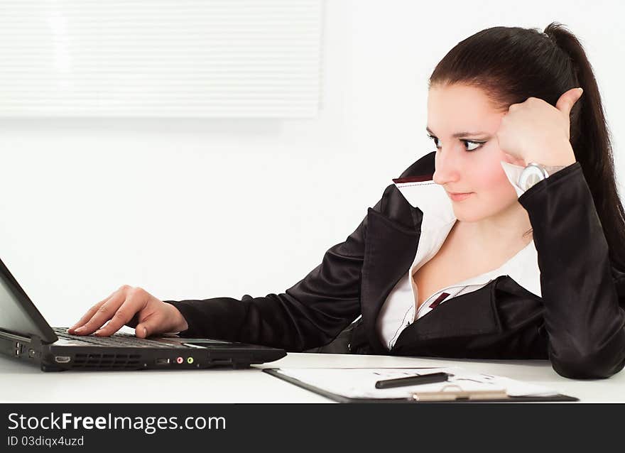 Woman in a business suit working in the office. Woman in a business suit working in the office