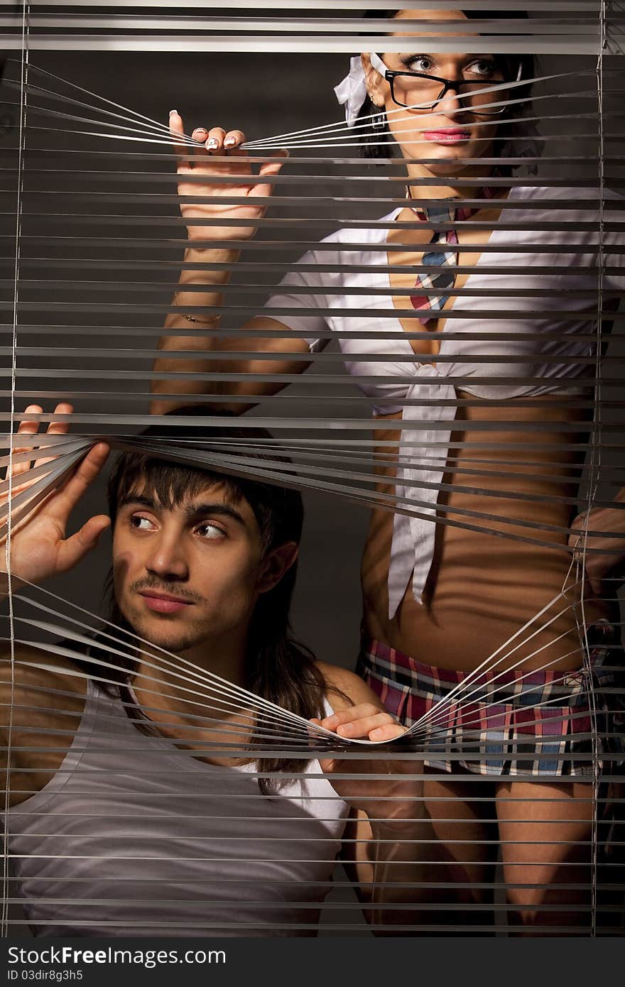 Young Couple observing through a jalousie