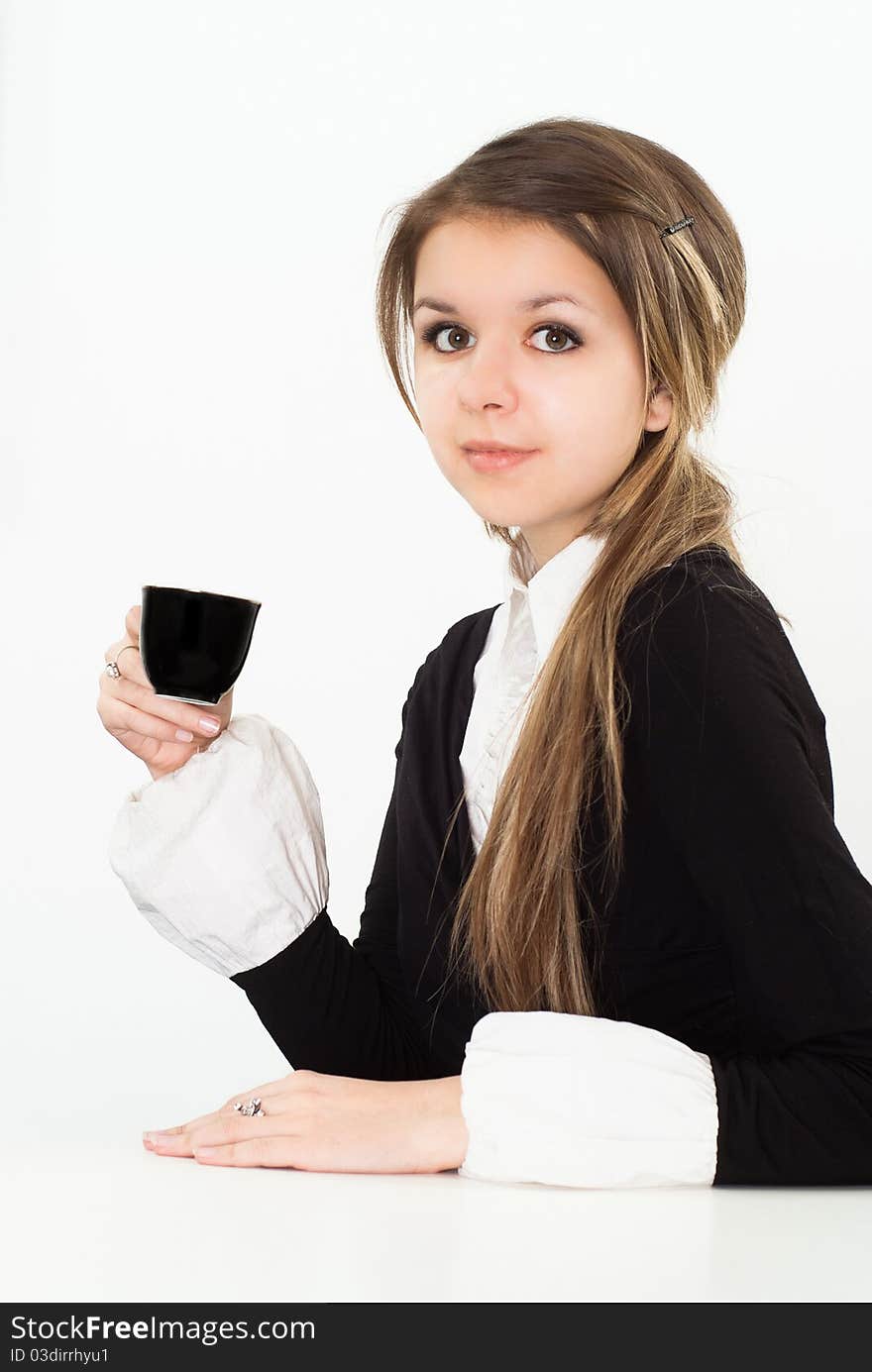 Beautiful woman drink in a black business suit with a white