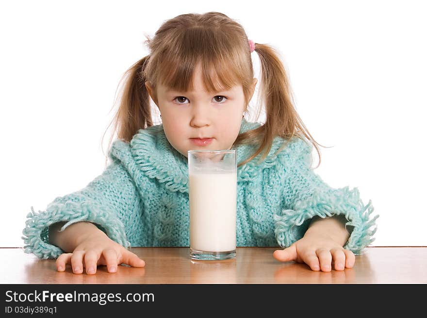 The little girl with a milk glass on white