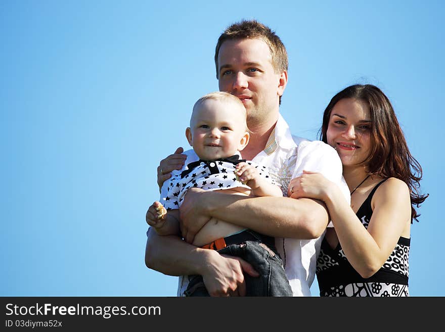 Happy family on blue sky background. Happy family on blue sky background