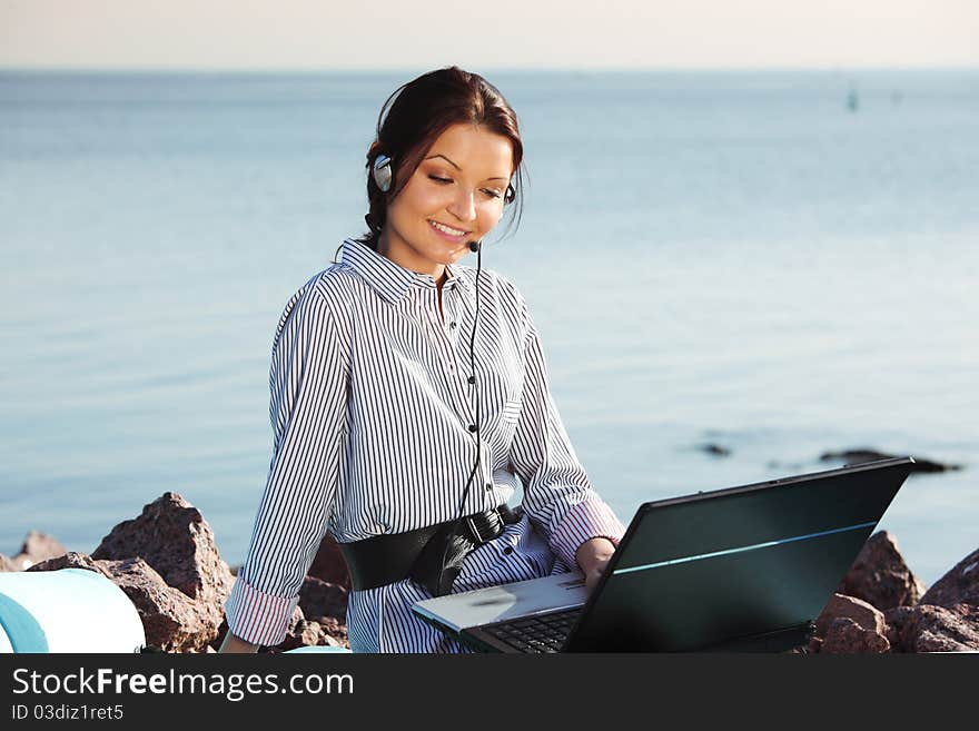 Woman work on laptop sea on background. Woman work on laptop sea on background