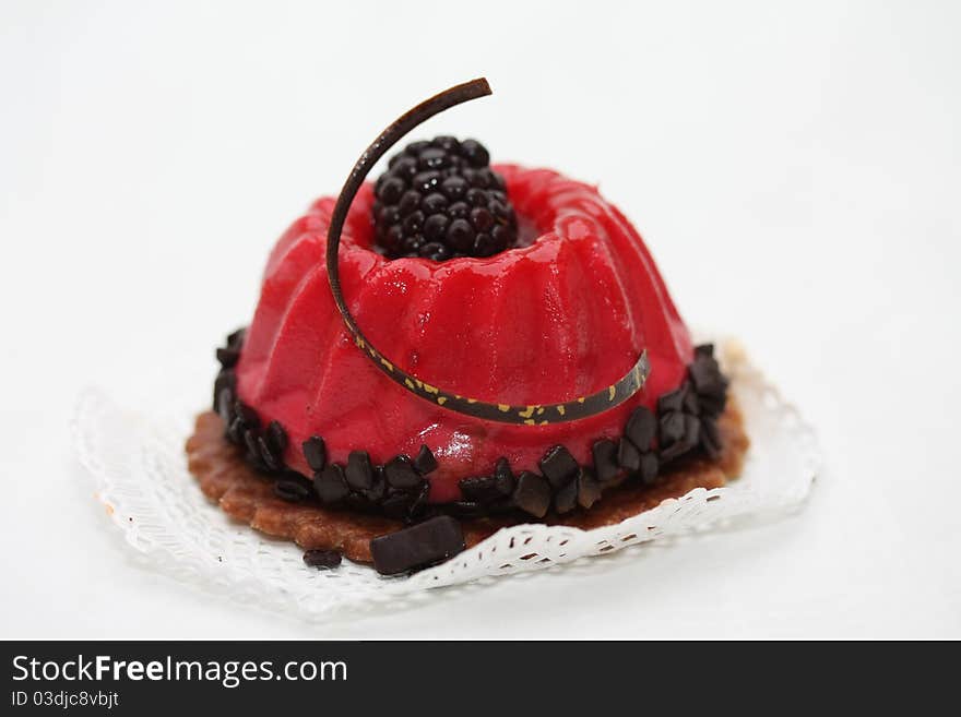 Red fruitcake with chocolate and bramble decoration. Red fruitcake with chocolate and bramble decoration