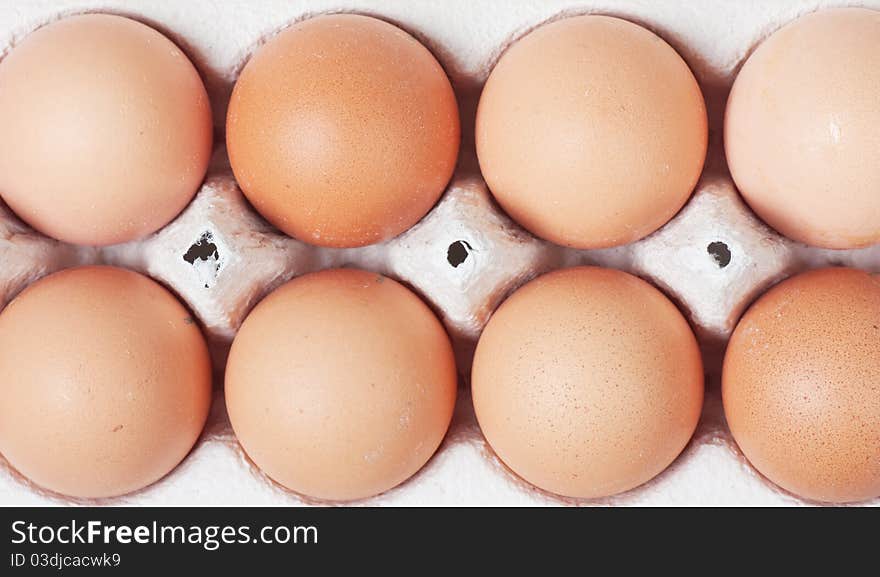 White eggs in carton. Nutritious eating.