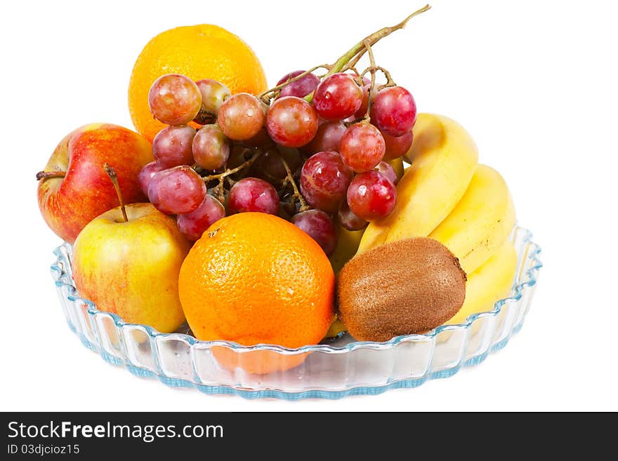 Fruits (apples, oranges, bananas, kiwi) on a plate