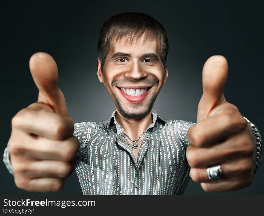 Young happy man going thumbs up