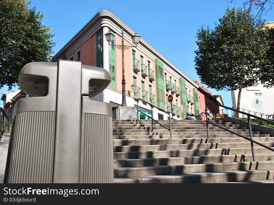 View of a garbage disposal in a pedestrian street. View of a garbage disposal in a pedestrian street