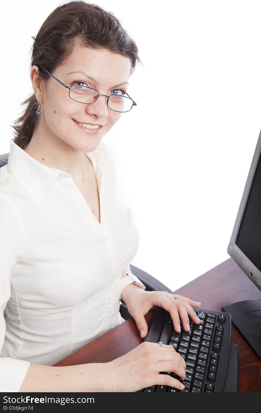 Smiling businesswoman at desk tft, portrait orientation