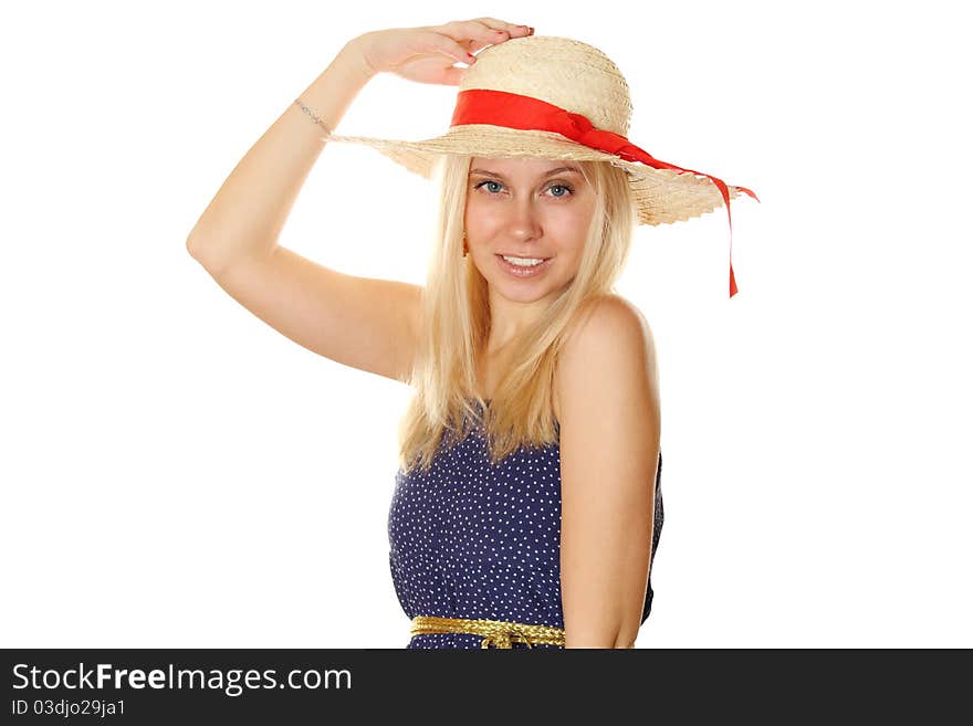 Beautiful young blond woman in a straw hat and a blue light summer dress.