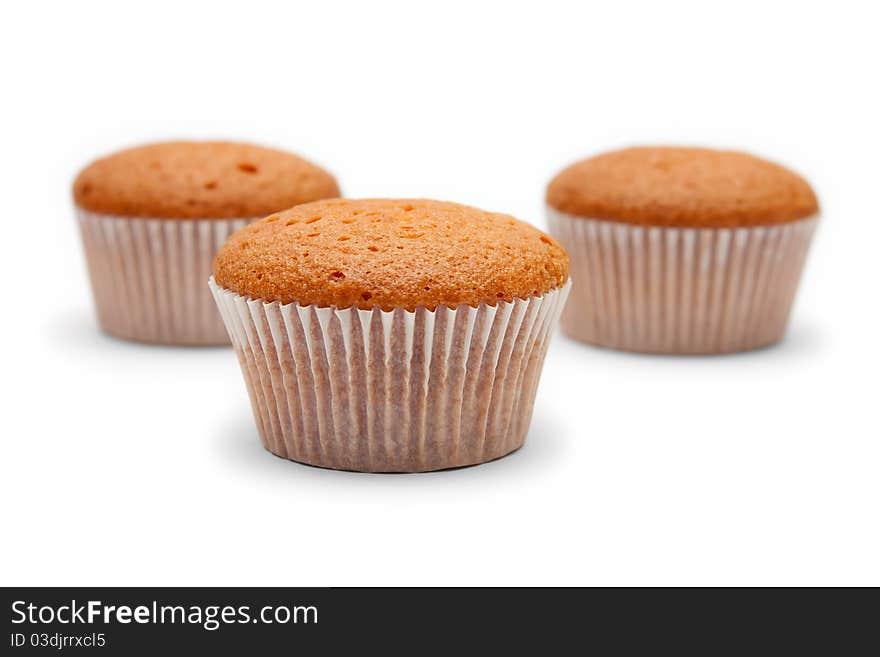 Three cakes in paper packing isolated on white