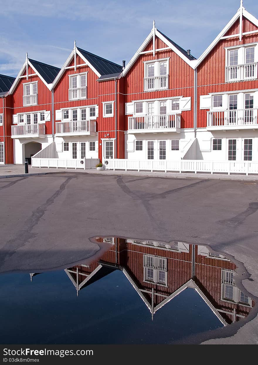 Modern classical design beach summer houses reflected perfectly in a small water pond. Modern classical design beach summer houses reflected perfectly in a small water pond