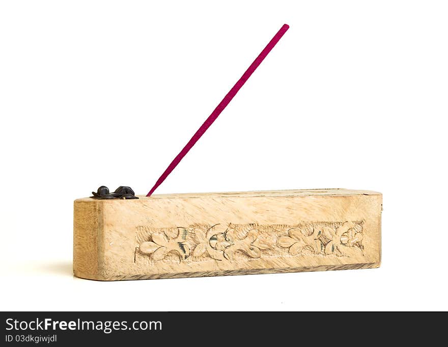 Carved wooden incense burner with joss stick isolated on white. Carved wooden incense burner with joss stick isolated on white.