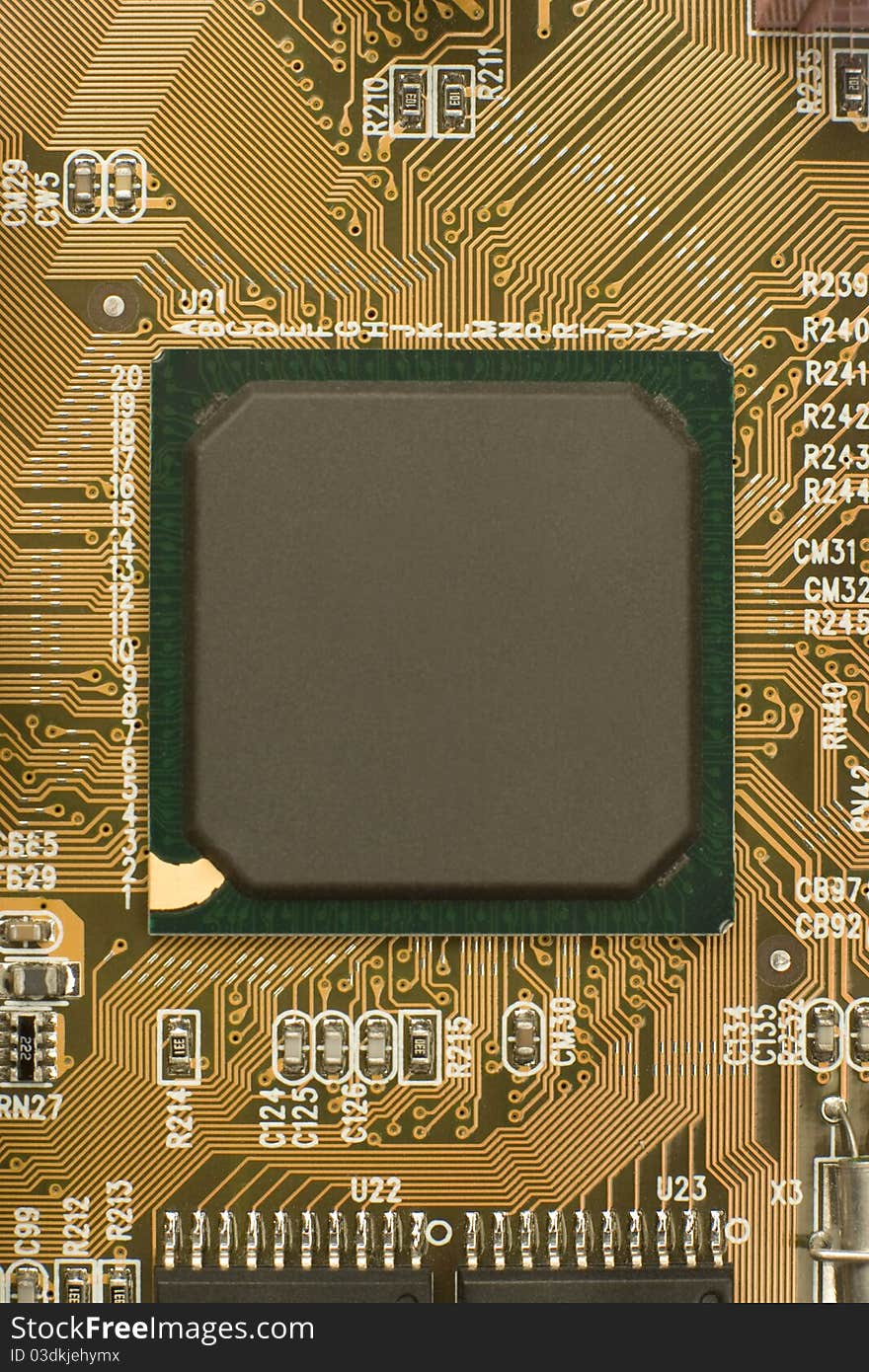 Black chip processor with green frame surrounded by brown orange circuit board - motherboard. Black chip processor with green frame surrounded by brown orange circuit board - motherboard