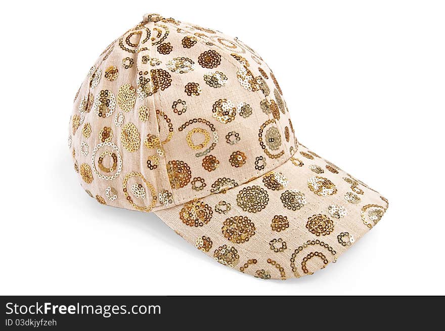 Beige cap with the pattern with a light shadow on a white background. Beige cap with the pattern with a light shadow on a white background