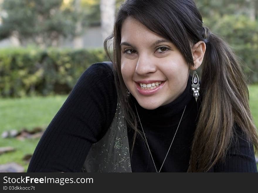 Beautiful Young Girl Smiling in a Park