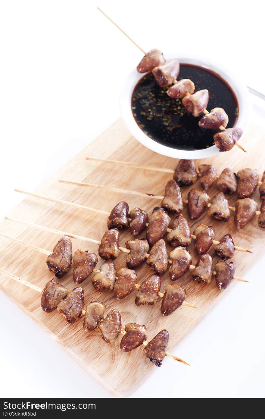 Grilled chicken hearts on skewers