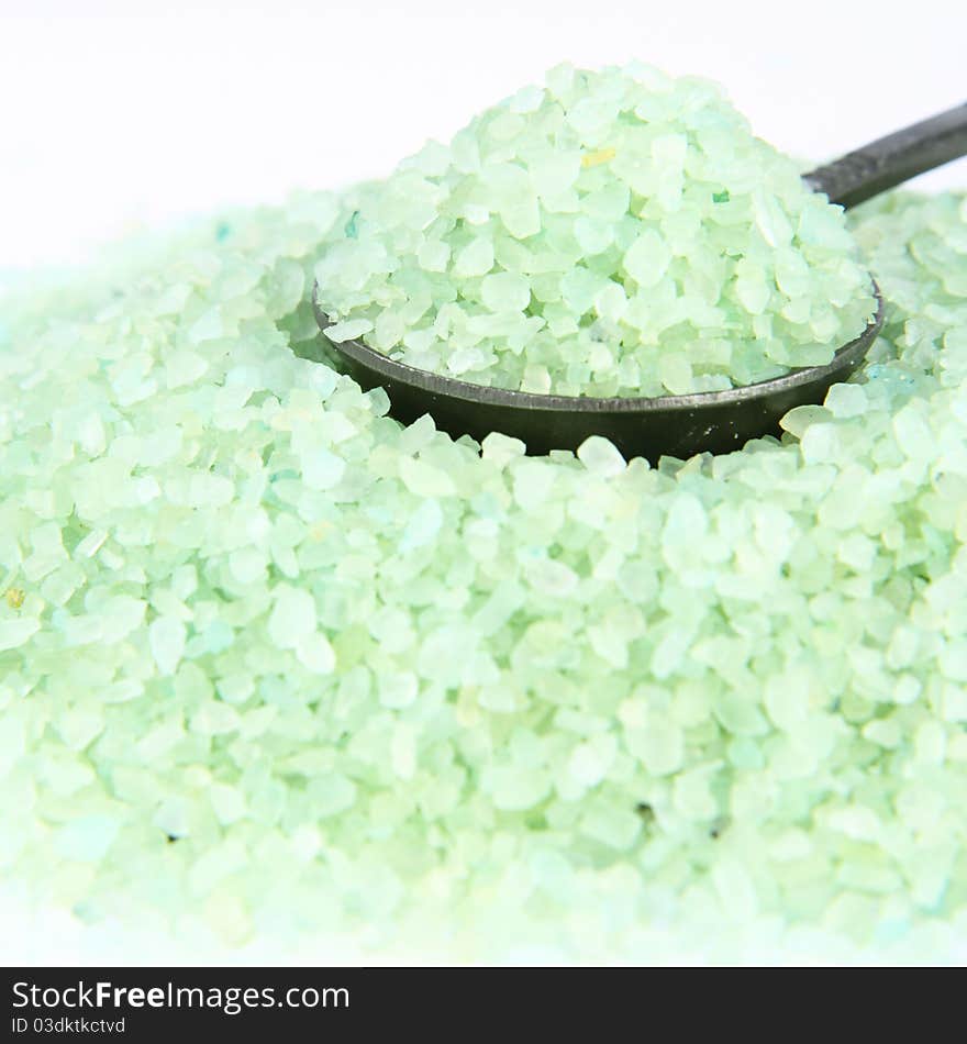 Green spa salt, some on an antique spoon