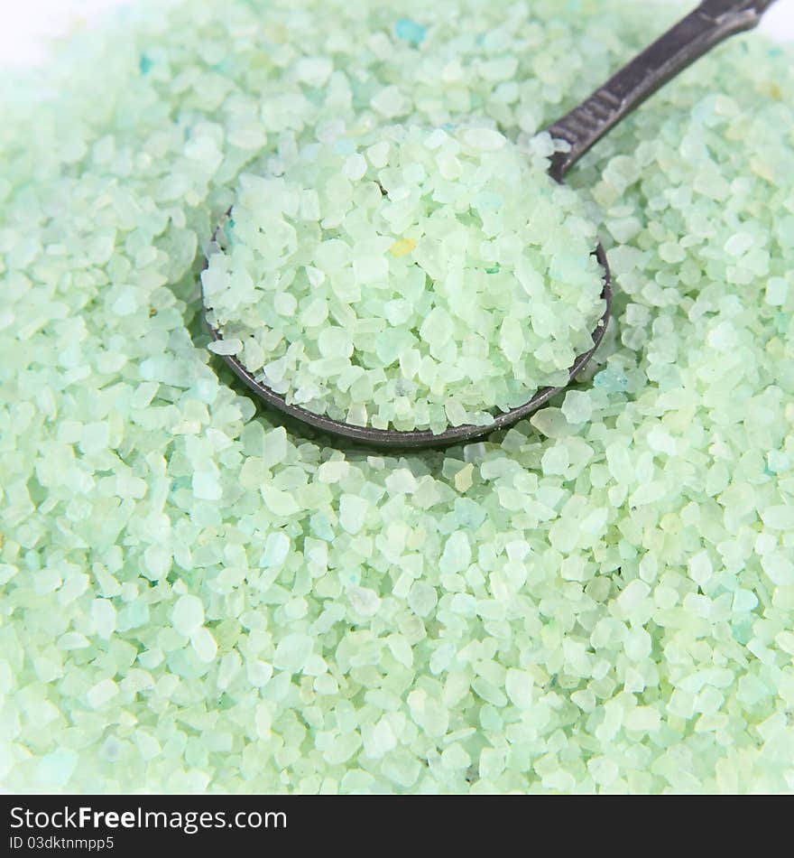 Green spa salt, some on an antique spoon