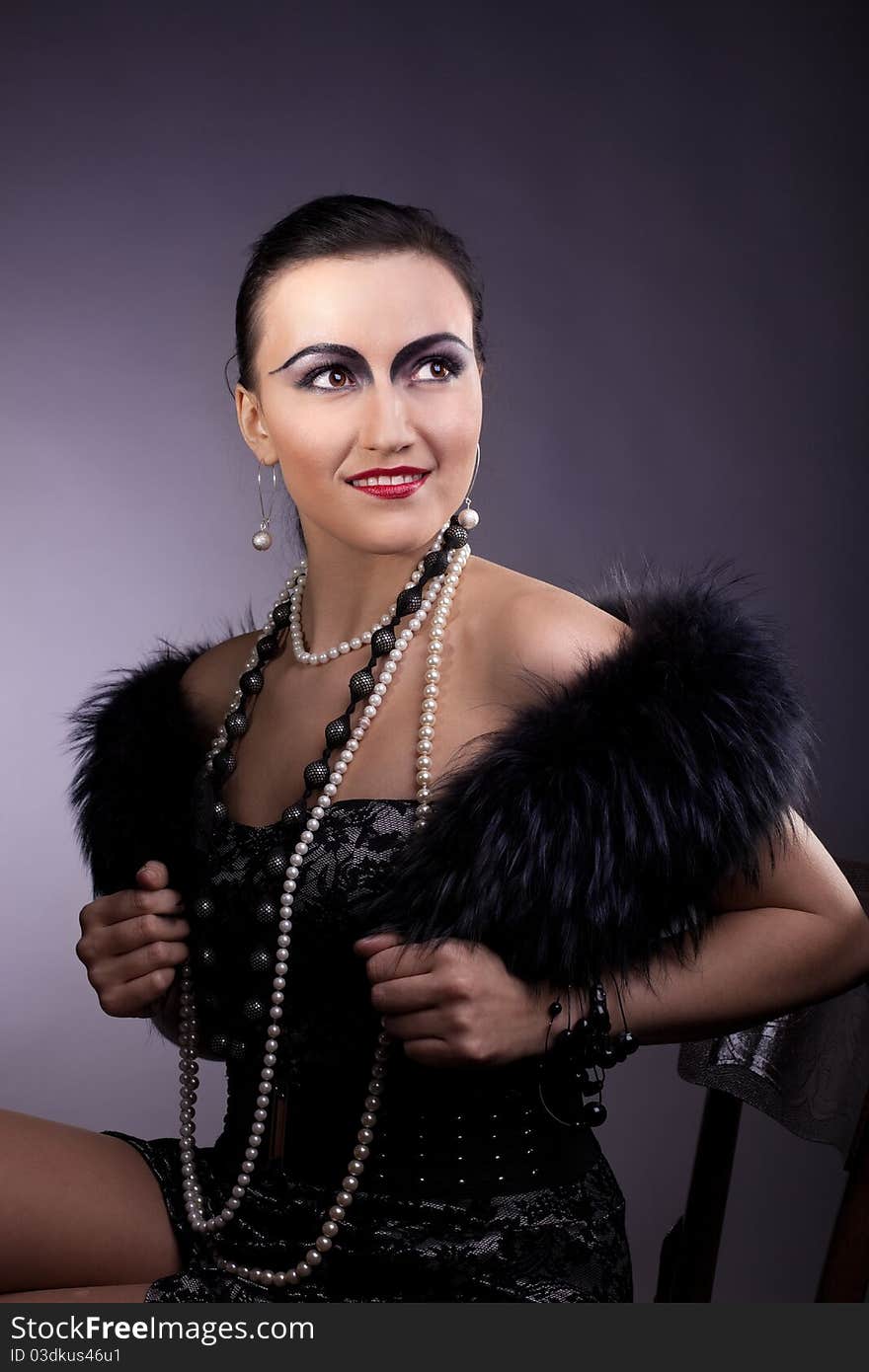 Woman smile in fur boa and pearl beads