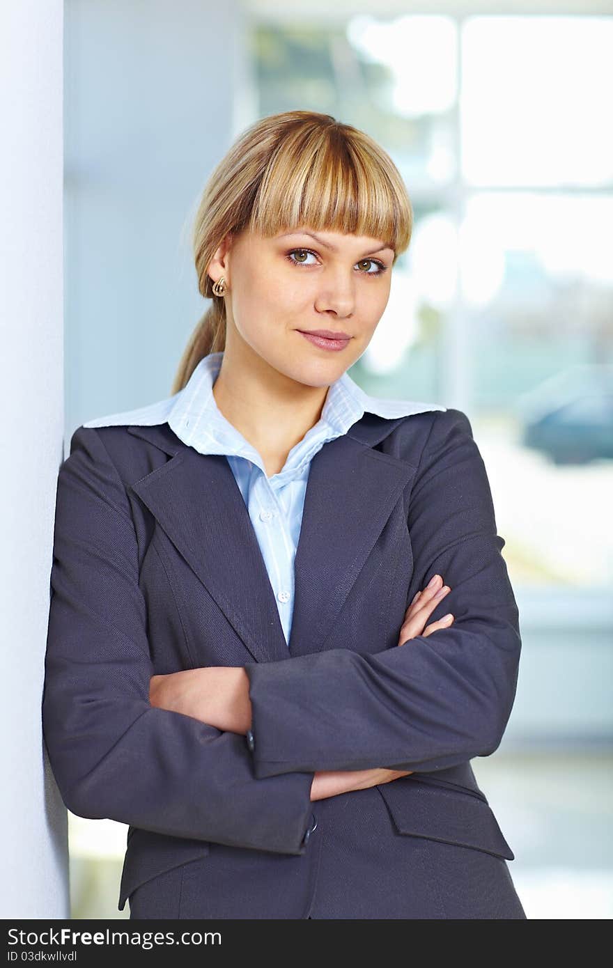 Young happy business woman standing casually with hands folded. Young happy business woman standing casually with hands folded