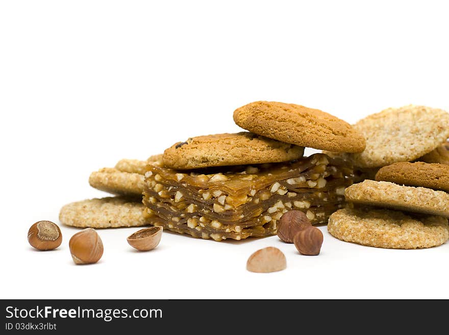 Sweet dessert: chocolate chip cookies, nougat and nuts isolated on a white background. Sweet dessert: chocolate chip cookies, nougat and nuts isolated on a white background