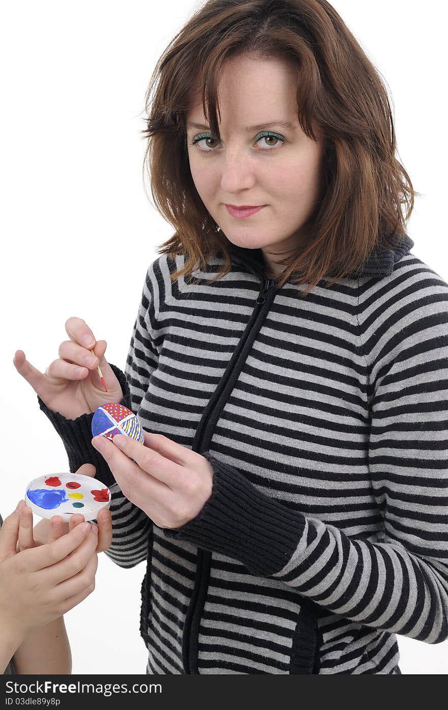 Young woman creating traditional eggs. Young woman creating traditional eggs