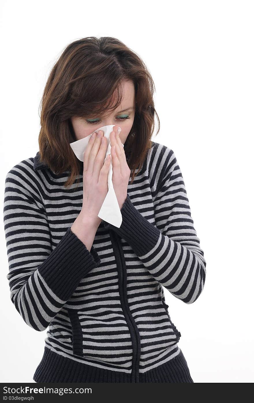 Sick woman blowing nose