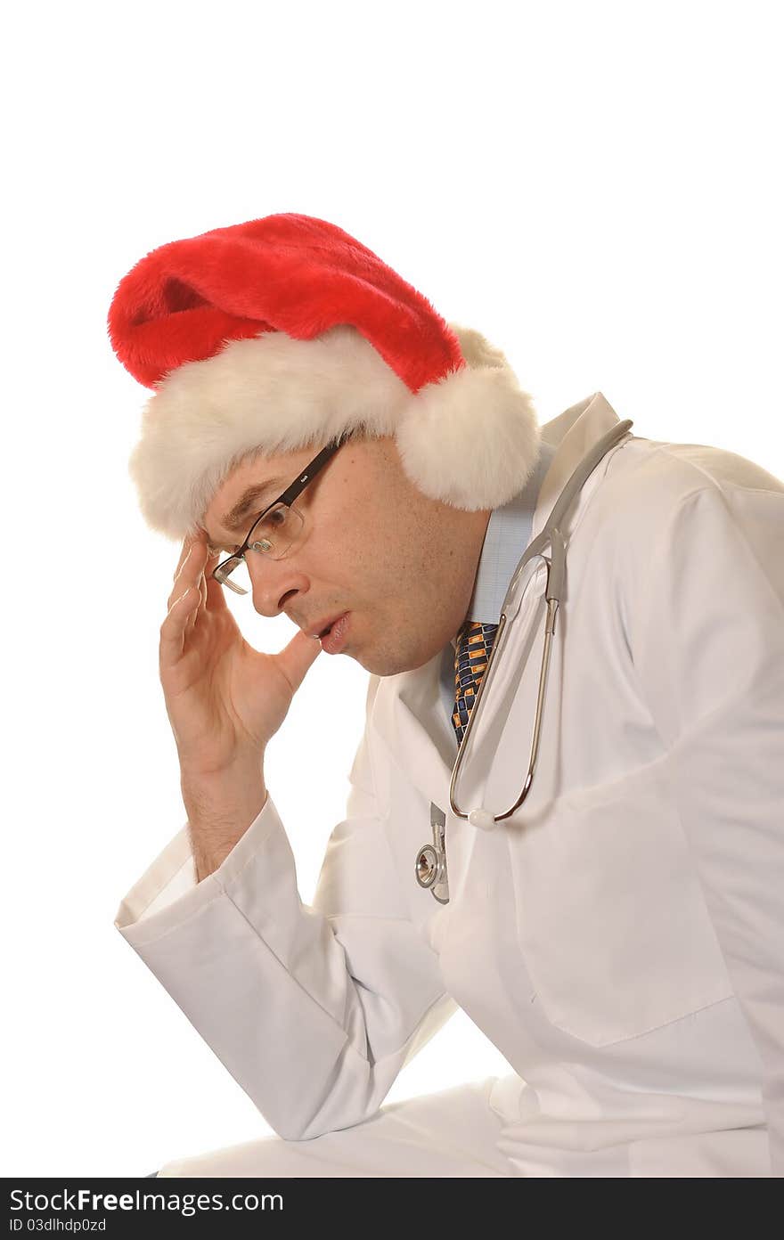 A sad sitting doctor with christmas hat. A sad sitting doctor with christmas hat