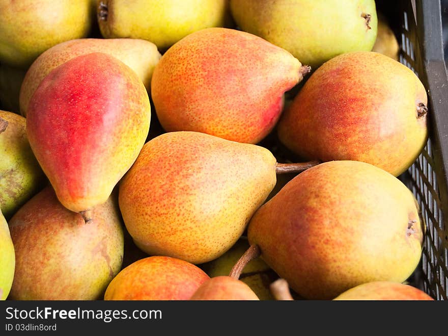 Freshly ripe pears in large boxes