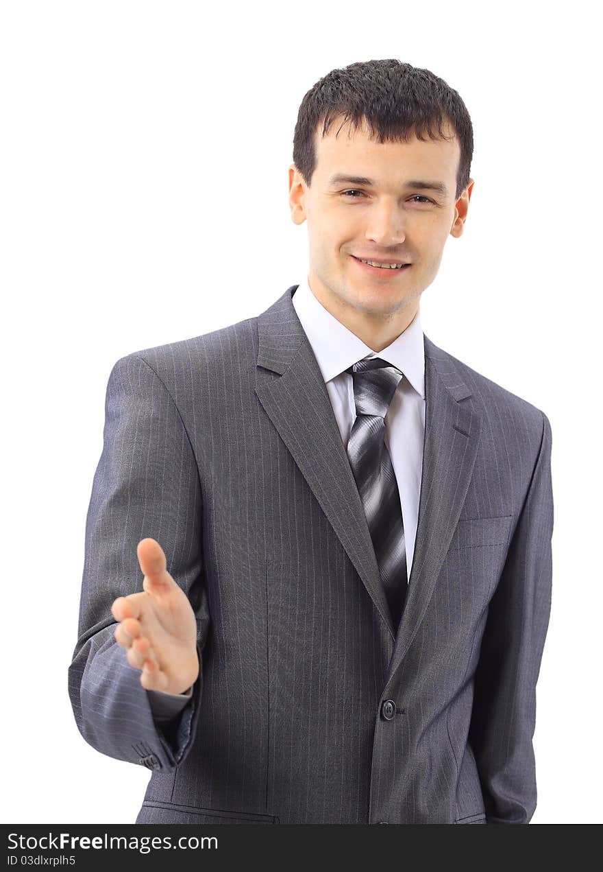 Portrait of a handsome young man in a business suit about to shake somebody's hand