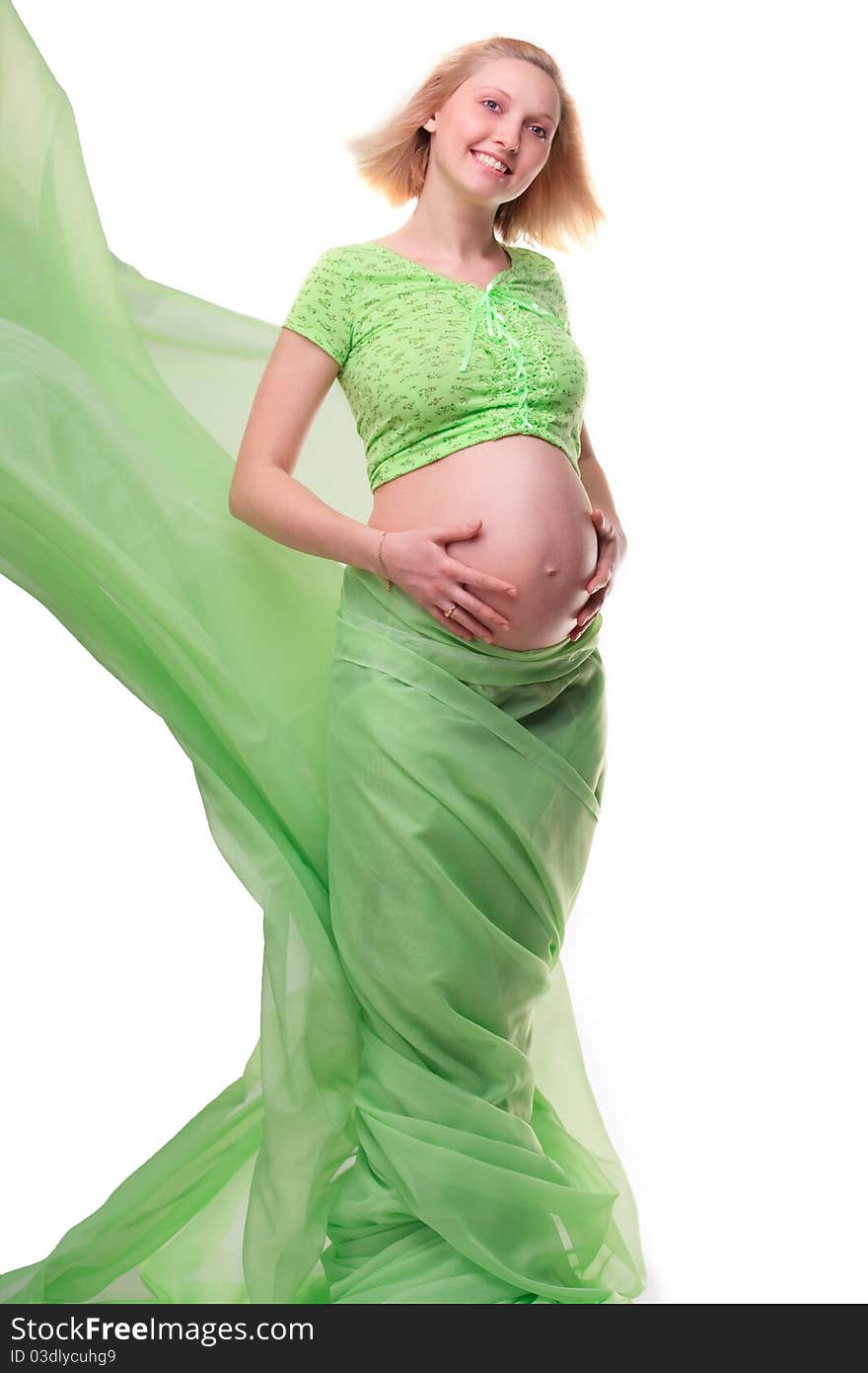 Beautiful young pregnant blonde woman with green transparent cloth in studio. Beautiful young pregnant blonde woman with green transparent cloth in studio