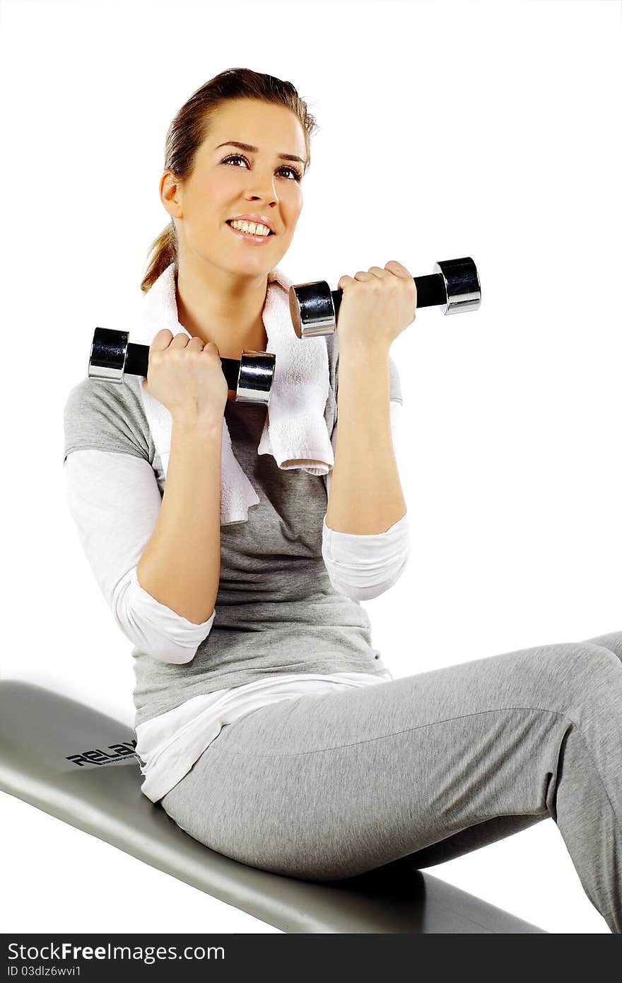 Girl sitting exercising with weights