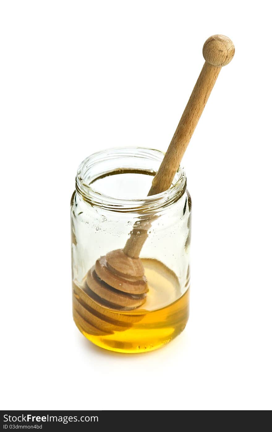 Honey in glass jar isolated