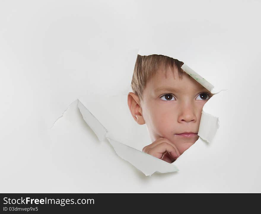 Child Looking Out From Hole In Paper